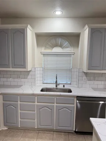 a kitchen with white cabinets and a sink
