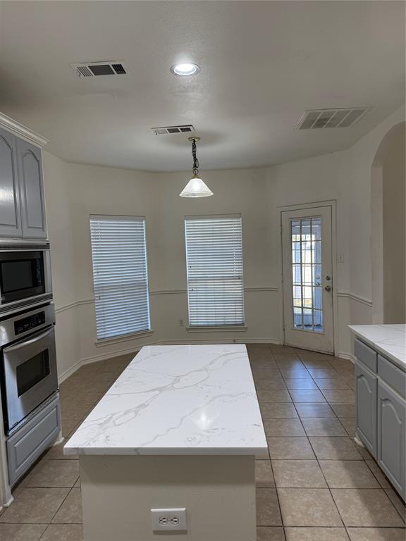 5817 Mulvane Drive Plano, TX 75094 - Photo 21 of 39 a kitchen with a sink stove and cabinets