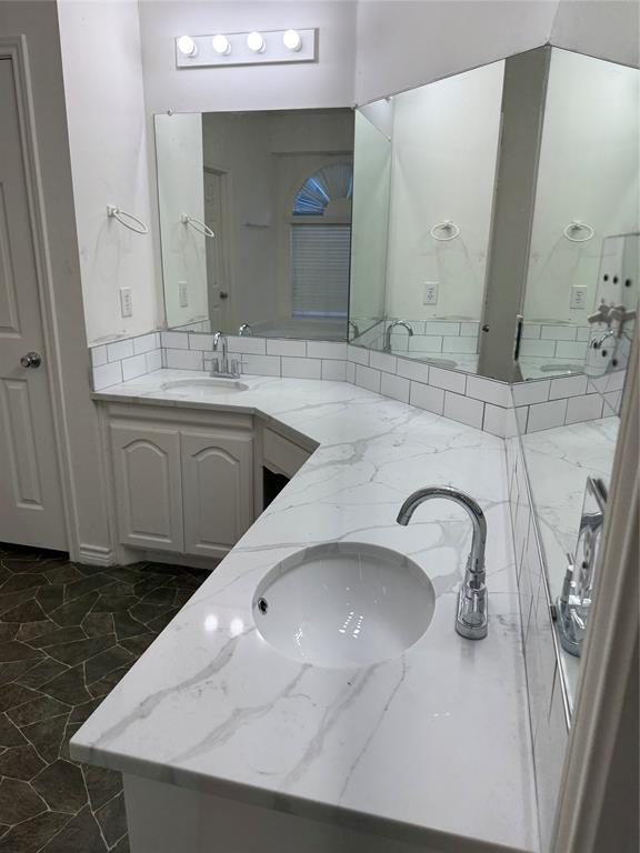 5817 Mulvane Drive Plano, TX 75094 - Photo 26 of 39 a bathroom with a sink and a mirror