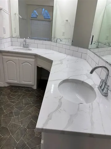 a bathroom with a sink and a mirror