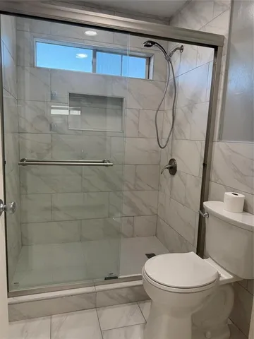 a bathroom with a toilet and shower