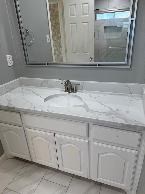5817 Mulvane Drive Plano, TX 75094 - Photo 31 of 39 a bathroom with a sink and a mirror