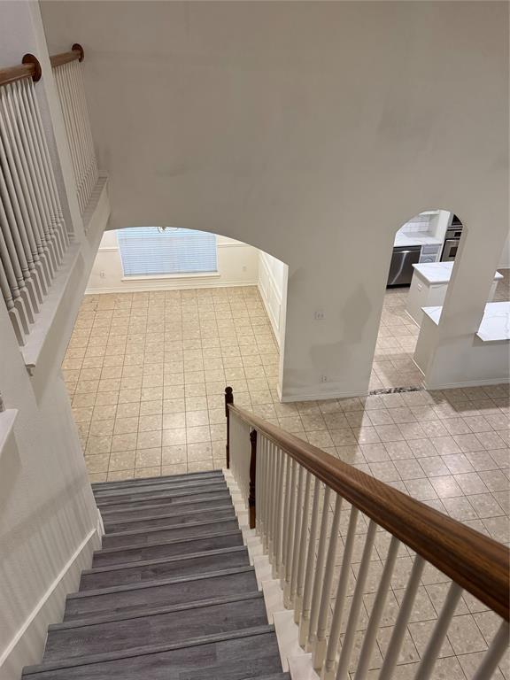 5817 Mulvane Drive Plano, TX 75094 - Photo 35 of 39 a view of a hallway with wooden floor and staircase