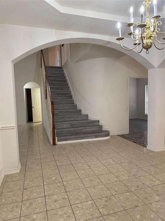 5817 Mulvane Drive Plano, TX 75094 - Photo 6 of 39 a view of a hallway with entryway and chandelier