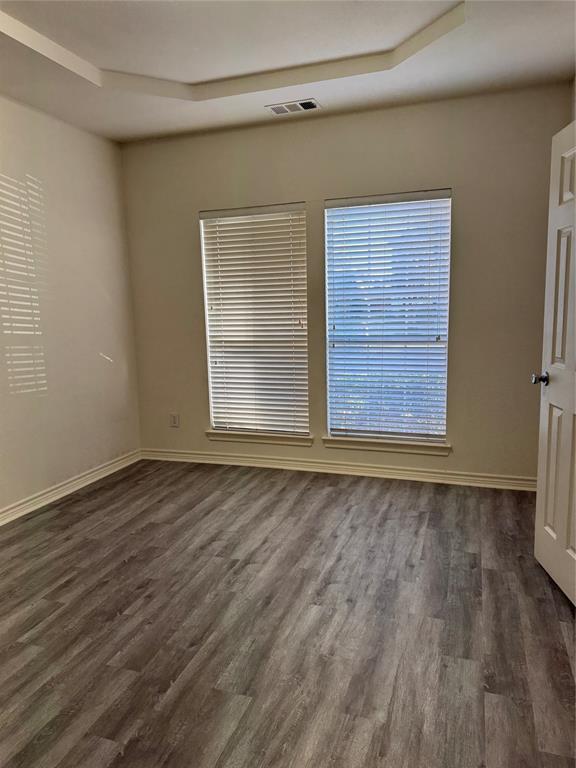 5817 Mulvane Drive Plano, TX 75094 - Photo 9 of 39 a view of an empty room with wooden floor and a window