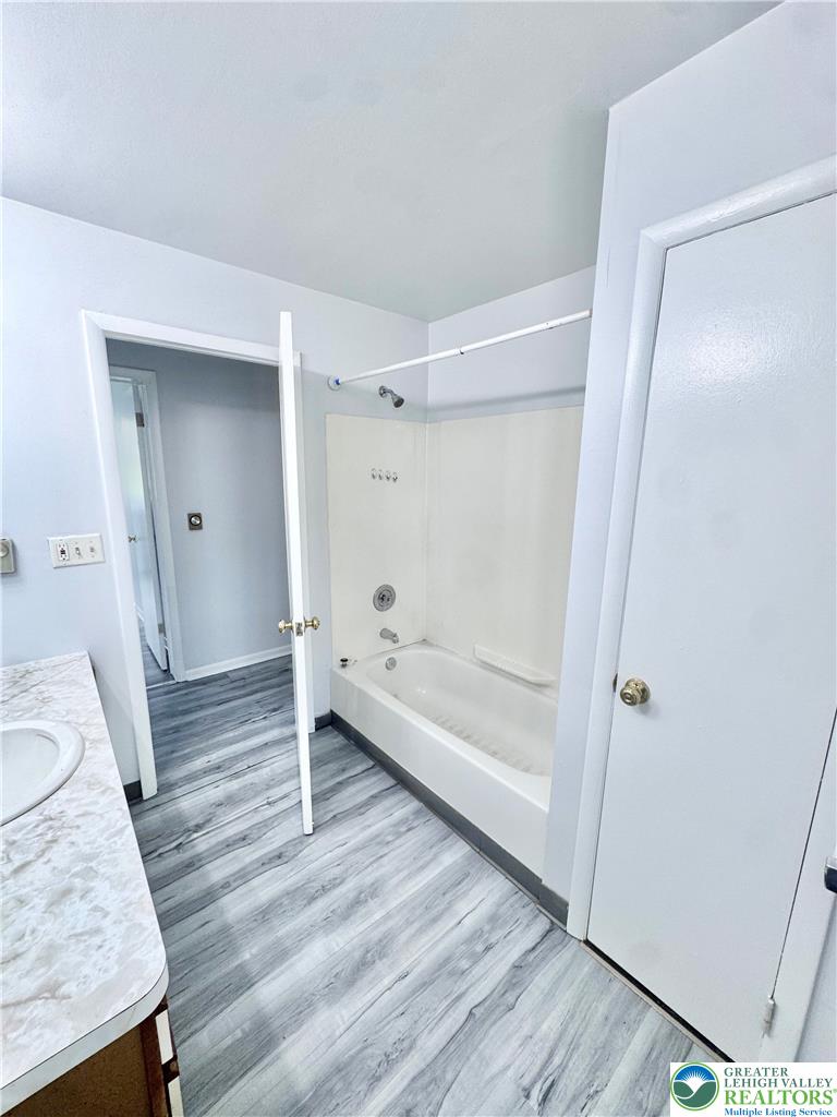 8361 Schantz Road, Unit 1 Breinigsville, PA 18031 - Photo 11 of 18 a bathroom with a tub shower and vanity