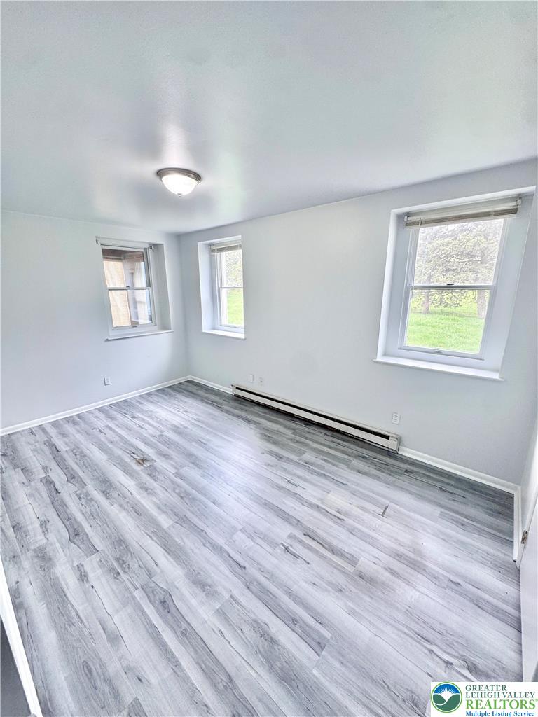 8361 Schantz Road, Unit 1 Breinigsville, PA 18031 - Photo 12 of 18 a view of empty room with wooden floor and fan