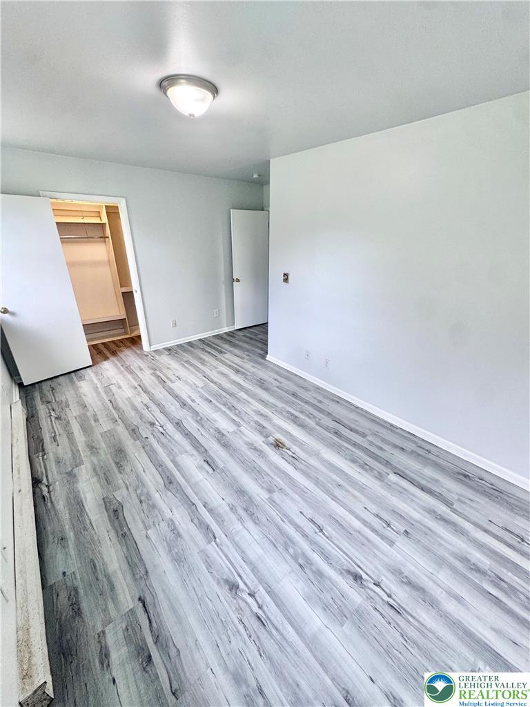 8361 Schantz Road, Unit 1 Breinigsville, PA 18031 - Photo 13 of 18 a view of empty room with wooden floor and fan