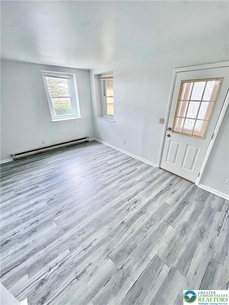 8361 Schantz Road, Unit 1 Breinigsville, PA 18031 - Photo 14 of 18 wooden floor in an empty room with a window