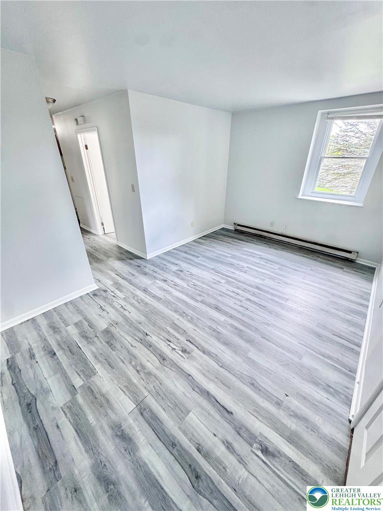 8361 Schantz Road, Unit 1 Breinigsville, PA 18031 - Photo 15 of 18 an empty room with wooden floor and windows