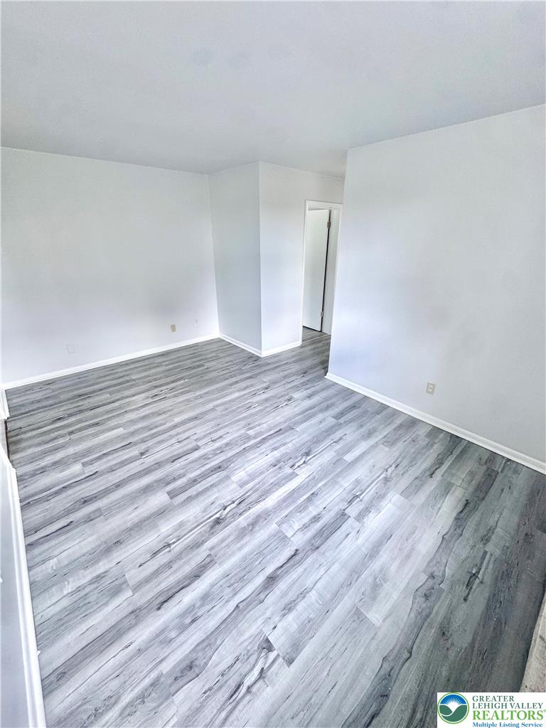 8361 Schantz Road, Unit 1 Breinigsville, PA 18031 - Photo 16 of 18 a view of an empty room with wooden floor