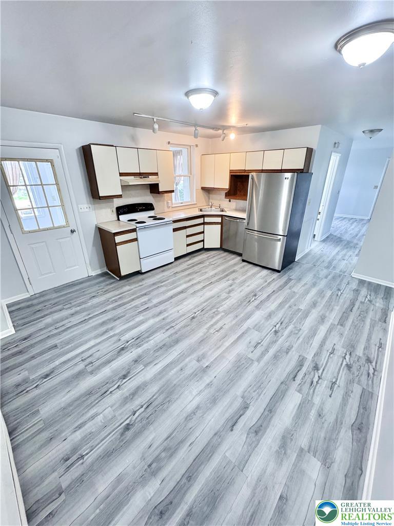 8361 Schantz Road, Unit 1 Breinigsville, PA 18031 - Photo 6 of 18 a view of kitchen with furniture and wooden floor