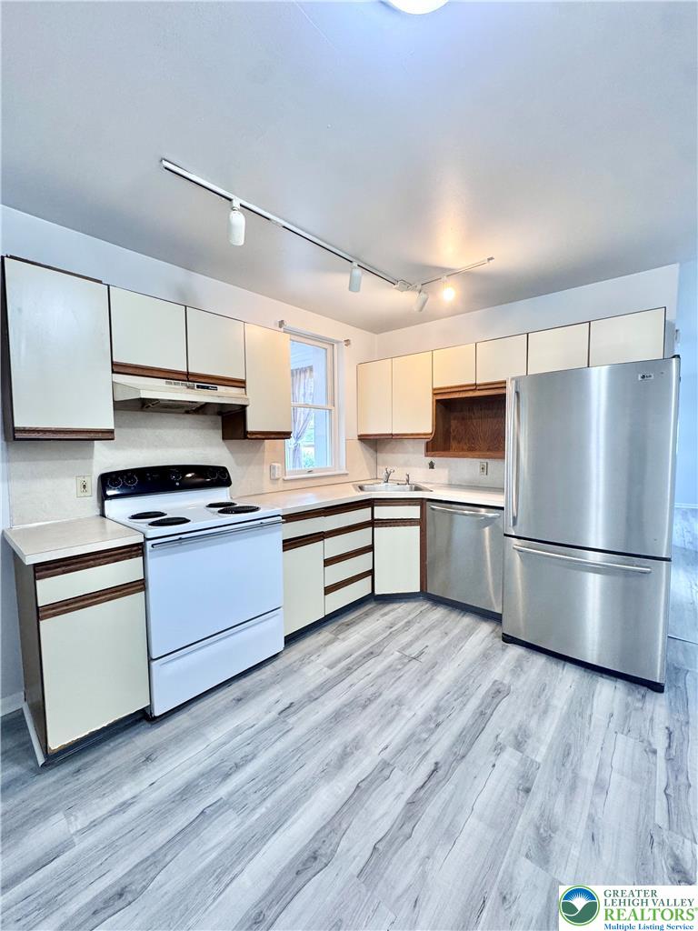 8361 Schantz Road, Unit 1 Breinigsville, PA 18031 - Photo 7 of 18 a kitchen with a refrigerator and a stove top oven