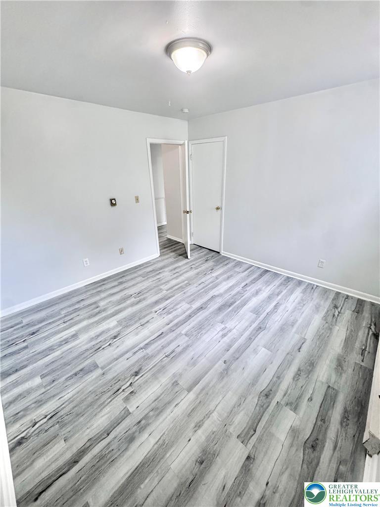 8361 Schantz Road, Unit 1 Breinigsville, PA 18031 - Photo 9 of 18 a view of an empty room with wooden floor