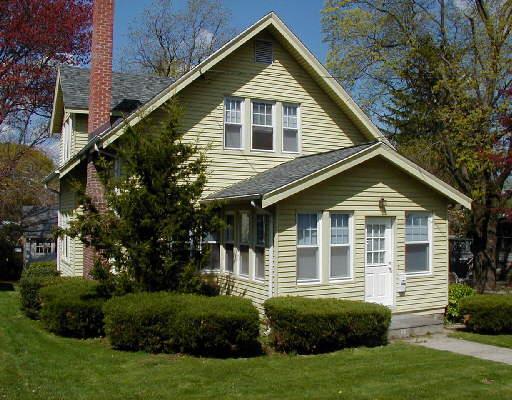 195 Toms Road Stamford, CT 06906 - Photo 1 of 1 a front view of a house with a yard