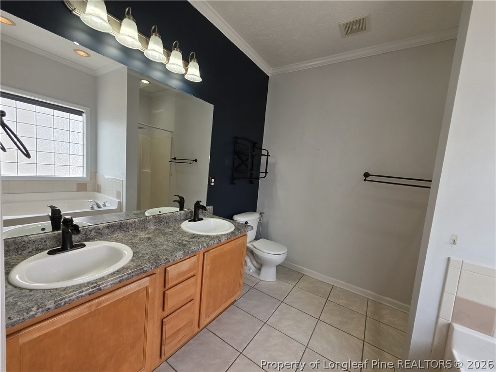 1324 Kershaw Loop, Unit 206 Fayetteville, NC 28314 - Photo 17 of 26 a bathroom with a sink toilet and mirror