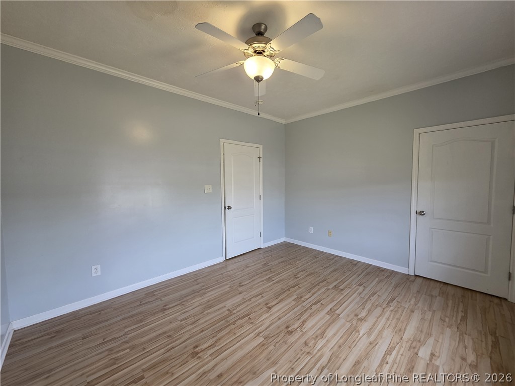1324 Kershaw Loop, Unit 206 Fayetteville, NC 28314 - Photo 20 of 26 wooden floor in an empty room with a chandelier fan