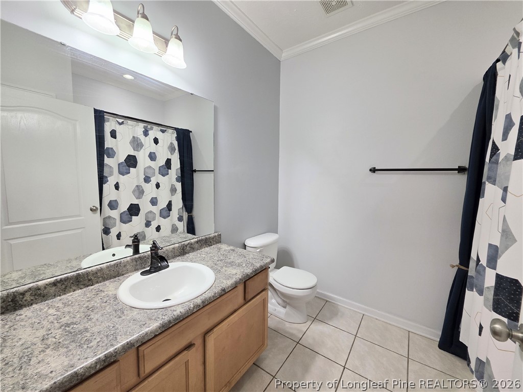 1324 Kershaw Loop, Unit 206 Fayetteville, NC 28314 - Photo 22 of 26 a bathroom with a granite countertop sink a toilet and a mirror