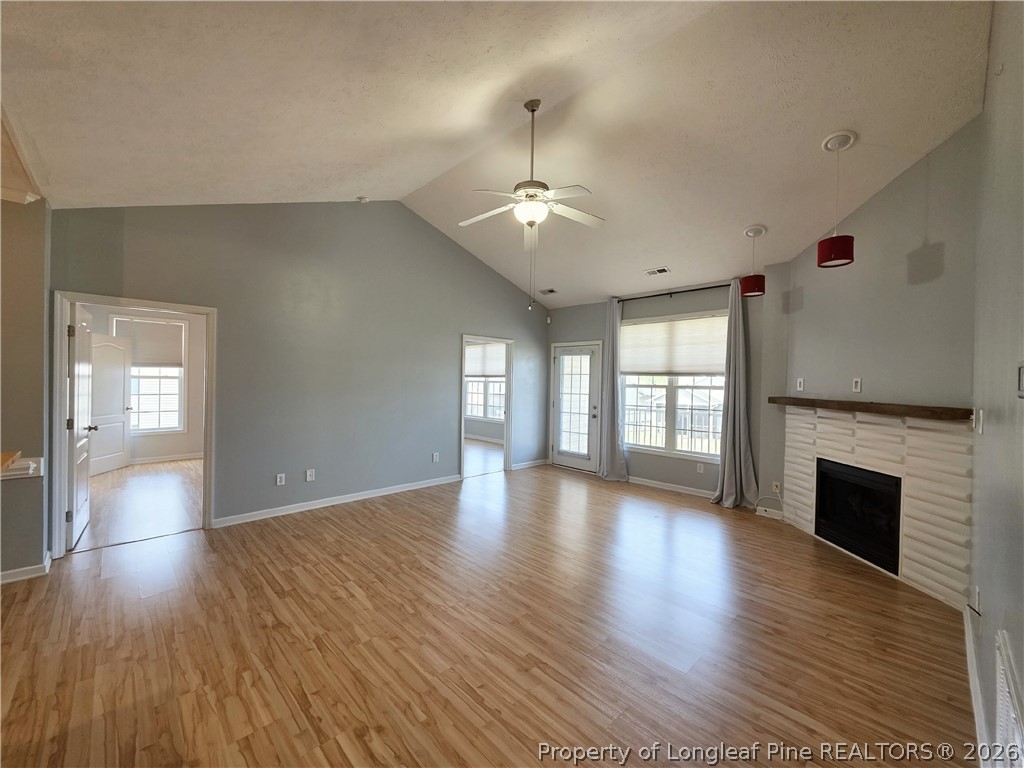 1324 Kershaw Loop, Unit 206 Fayetteville, NC 28314 - Photo 5 of 26 a view of an empty room with wooden floor and a window