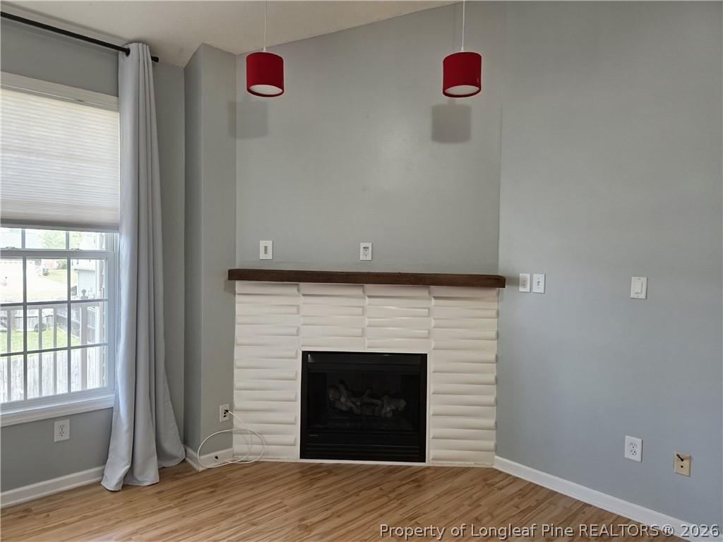 1324 Kershaw Loop, Unit 206 Fayetteville, NC 28314 - Photo 6 of 26 a view of a room with wooden floor and a fireplace