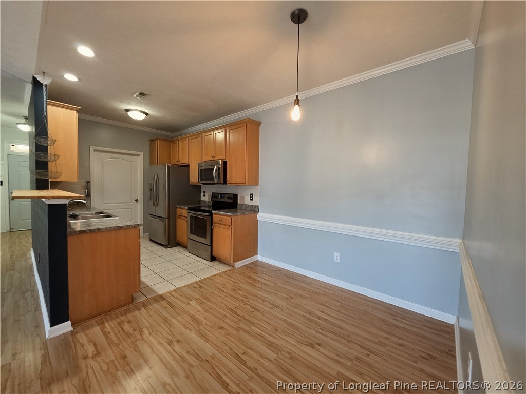 1324 Kershaw Loop, Unit 206 Fayetteville, NC 28314 - Photo 8 of 26 a kitchen with stainless steel appliances granite countertop a refrigerator a sink a stove and a wooden floors