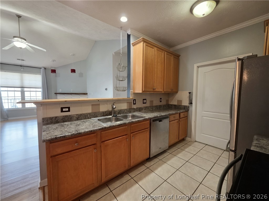 1324 Kershaw Loop, Unit 206 Fayetteville, NC 28314 - Photo 9 of 26 a large kitchen with a refrigerator a sink and a stove