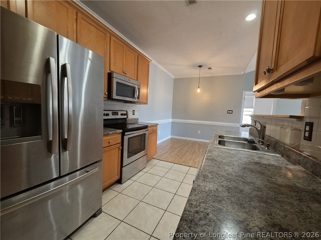 1324 Kershaw Loop, Unit 206 Fayetteville, NC 28314 - Photo 10 of 26 a kitchen with stainless steel appliances granite countertop a refrigerator a stove and a sink