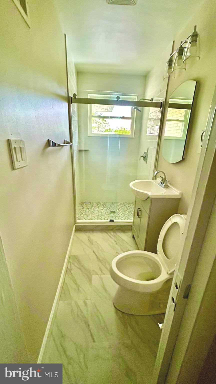 5319 Pooks Hill Road, Unit 1 Bethesda, MD 20814 - Photo 23 of 37 a bathroom with a sink a toilet and a mirror