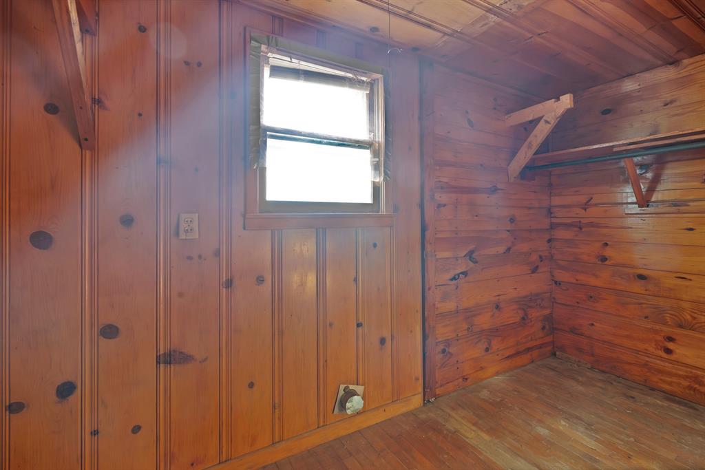 202 Johns Road Chico, TX 76431 - Photo 24 of 33 a view of an empty room with wooden floor and a window