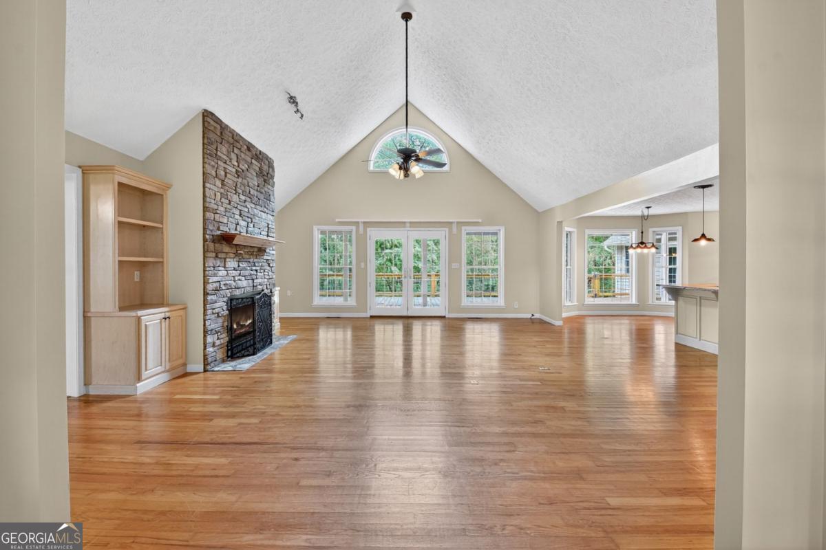 344 Cascade Lane Blue Ridge, GA 30513 - Photo 23 of 62 a view of an empty room with wooden floor and a window