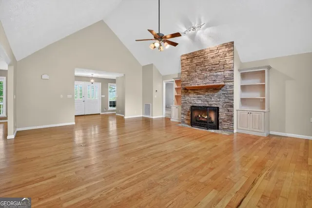 a kitchen with stainless steel appliances granite countertop a refrigerator a stove a sink and a oven