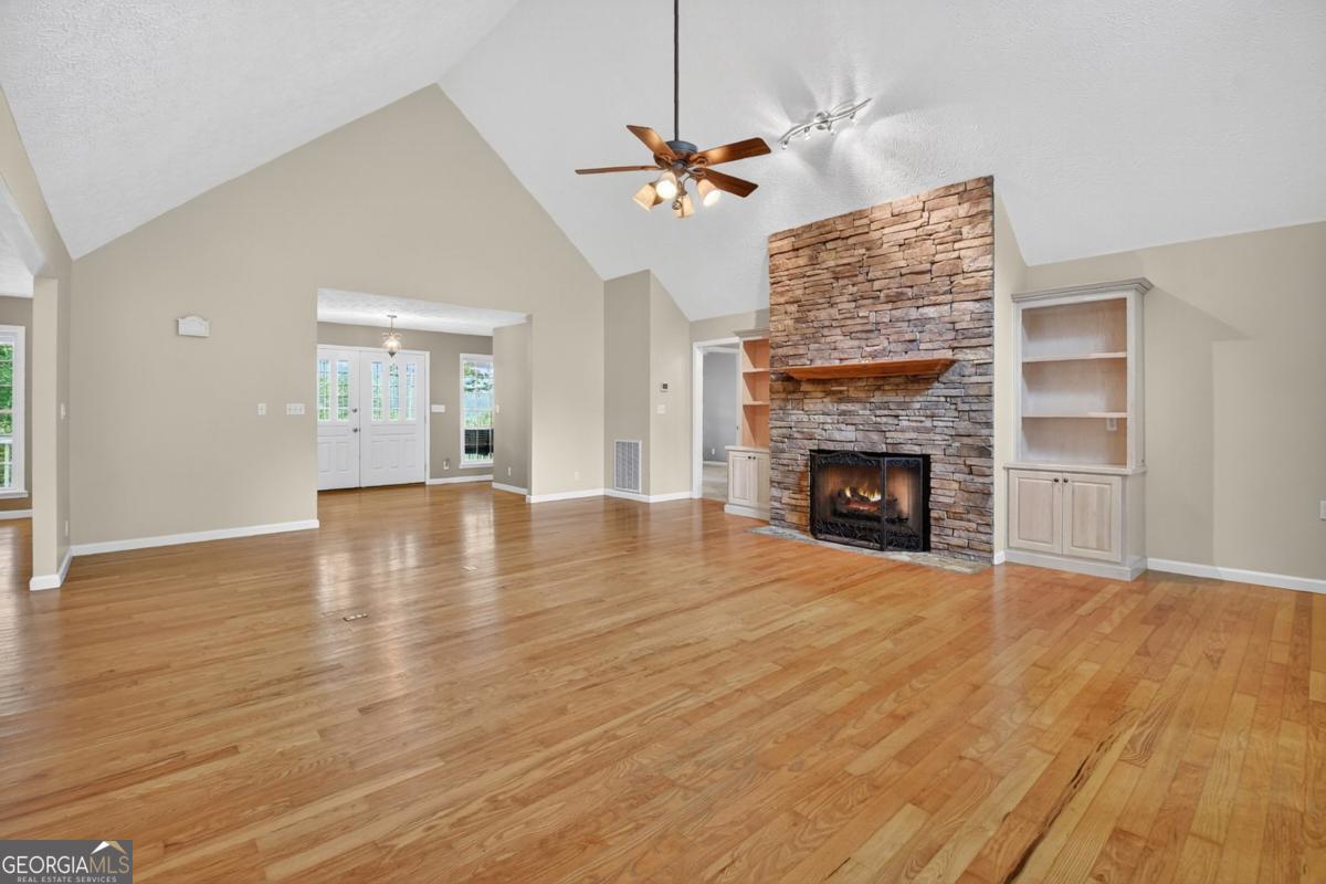 344 Cascade Lane Blue Ridge, GA 30513 - Photo 24 of 62 a view of an empty room with wooden floor fireplace and a window