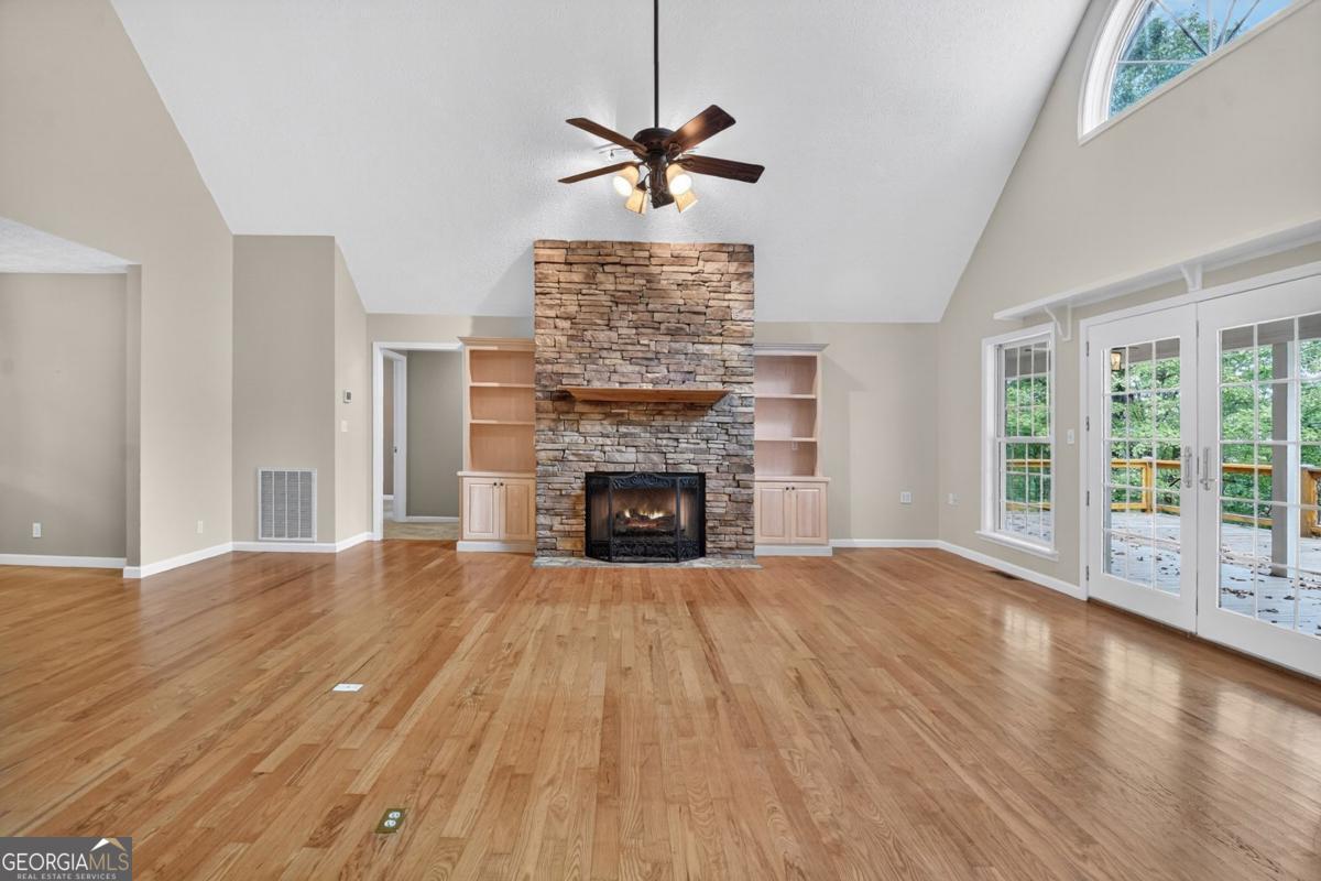 344 Cascade Lane Blue Ridge, GA 30513 - Photo 25 of 62 a view of an empty room with wooden floor fireplace and a window