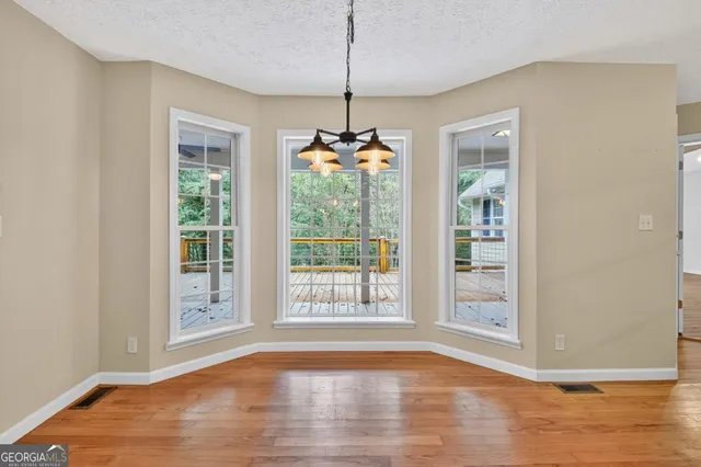 a kitchen with granite countertop white cabinets and stainless steel appliances