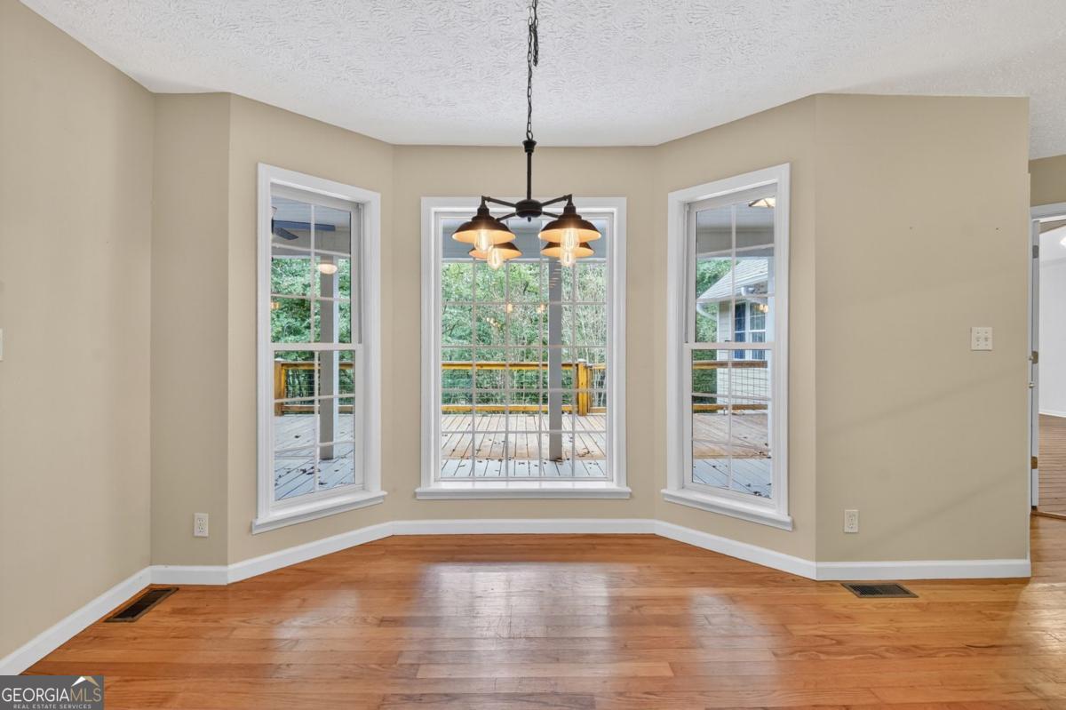 344 Cascade Lane Blue Ridge, GA 30513 - Photo 27 of 62 a view of empty room with wooden floor and fan