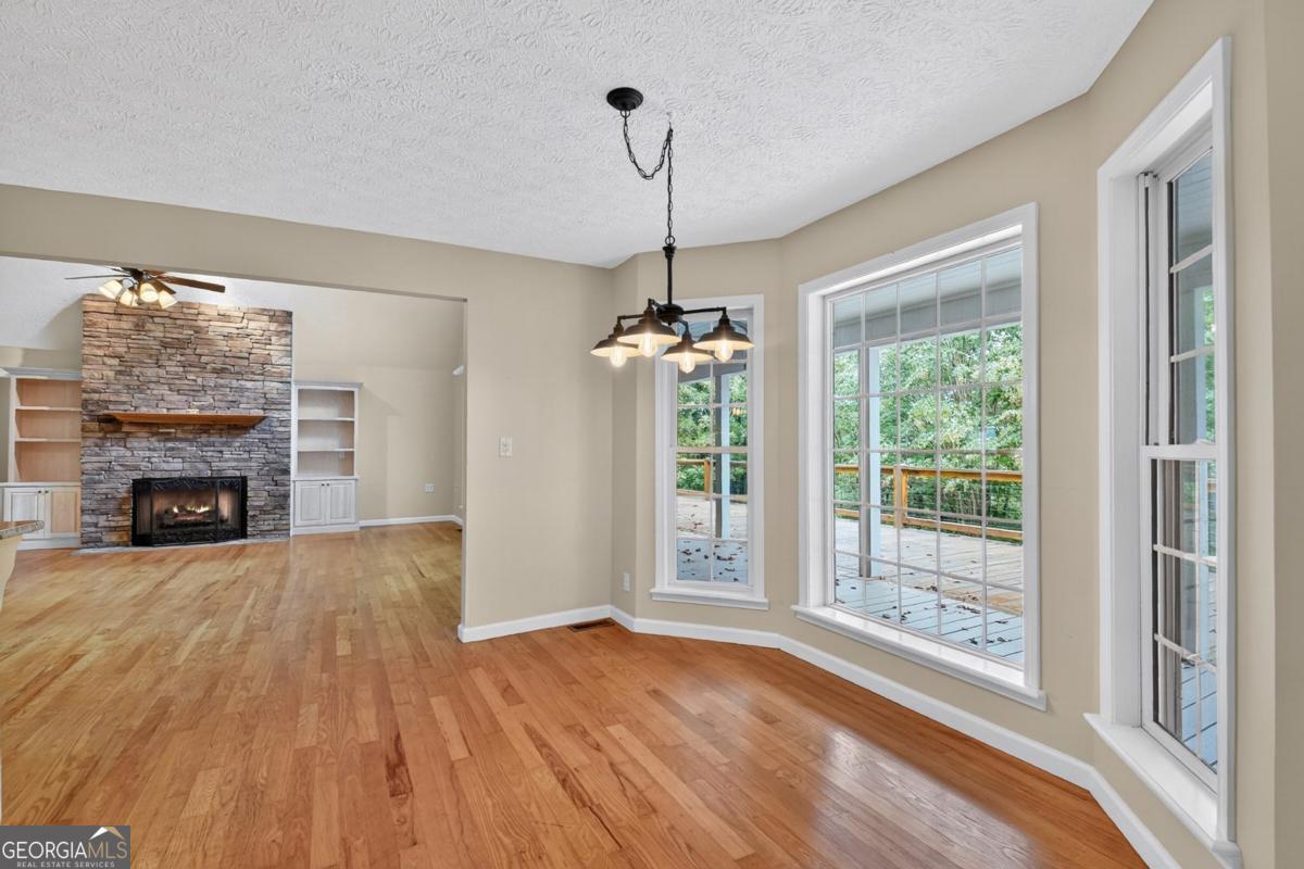 344 Cascade Lane Blue Ridge, GA 30513 - Photo 28 of 62 a view of empty room with wooden floor and fireplace