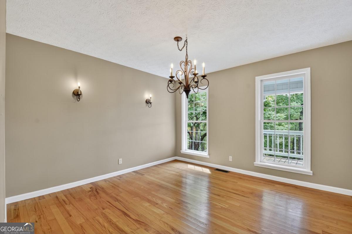 344 Cascade Lane Blue Ridge, GA 30513 - Photo 30 of 62 a view of an empty room with wooden floor and a window