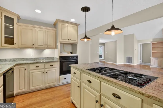 an empty room with windows and fireplace