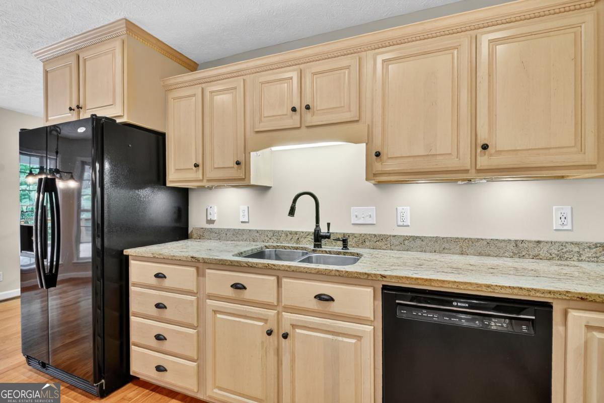 344 Cascade Lane Blue Ridge, GA 30513 - Photo 35 of 62 a kitchen with granite countertop white cabinets and stainless steel appliances