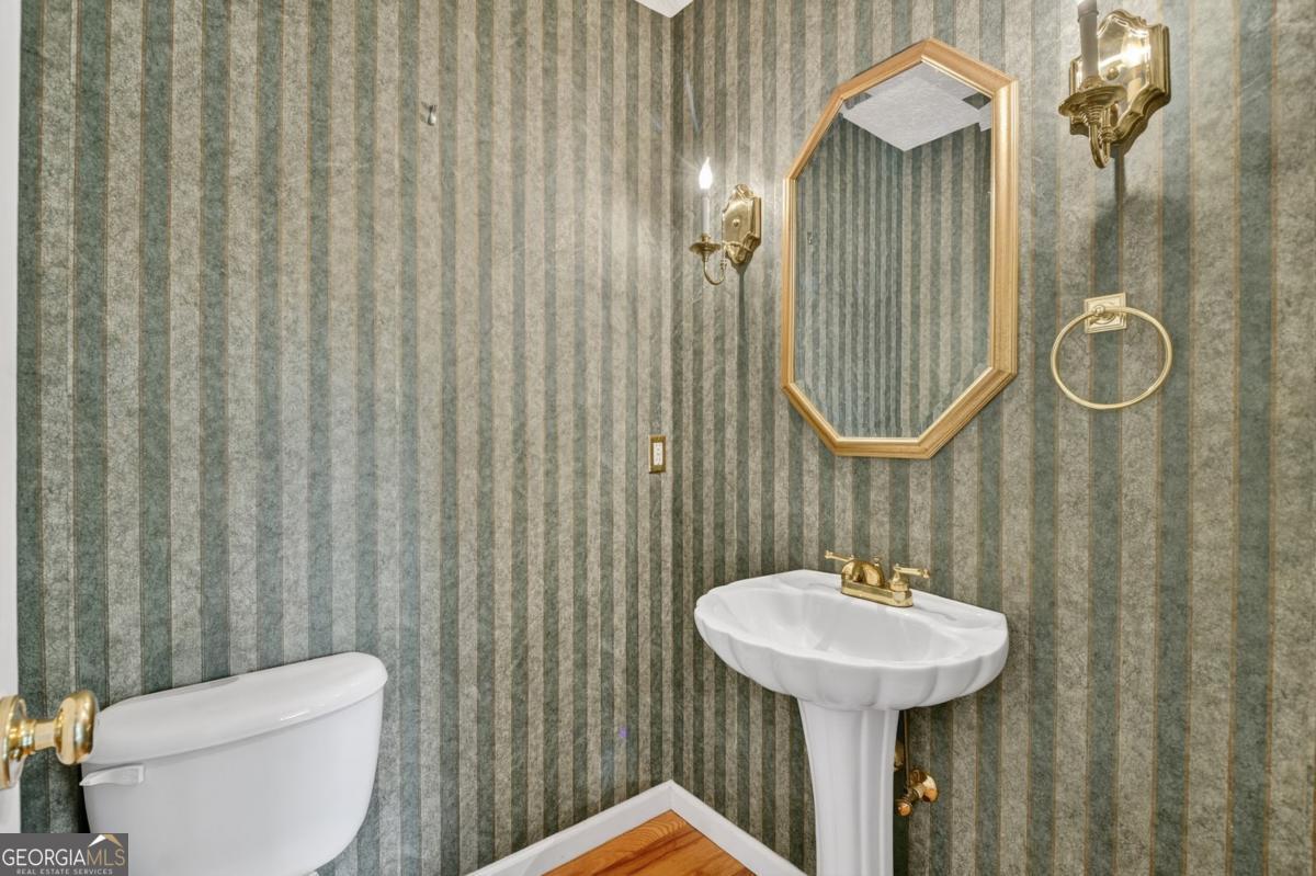 344 Cascade Lane Blue Ridge, GA 30513 - Photo 36 of 62 a bathroom with a toilet sink and mirror