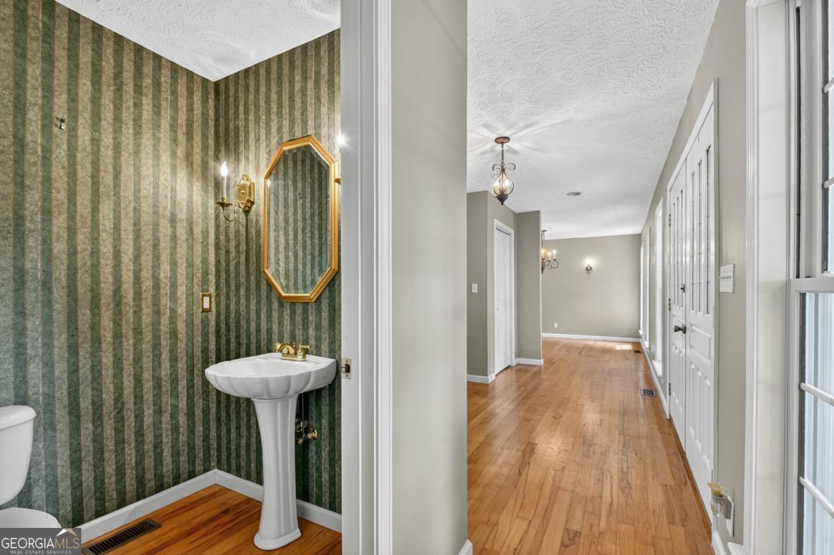 344 Cascade Lane Blue Ridge, GA 30513 - Photo 37 of 62 a view of a bathroom with a sink and mirror