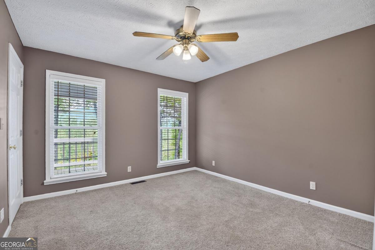 344 Cascade Lane Blue Ridge, GA 30513 - Photo 38 of 62 an empty room with windows and fan