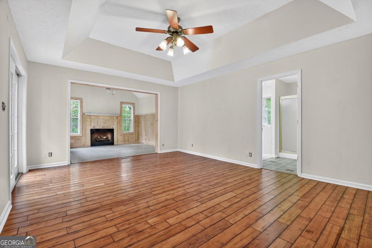 344 Cascade Lane Blue Ridge, GA 30513 - Photo 41 of 62 a view of empty room with wooden floor and fan
