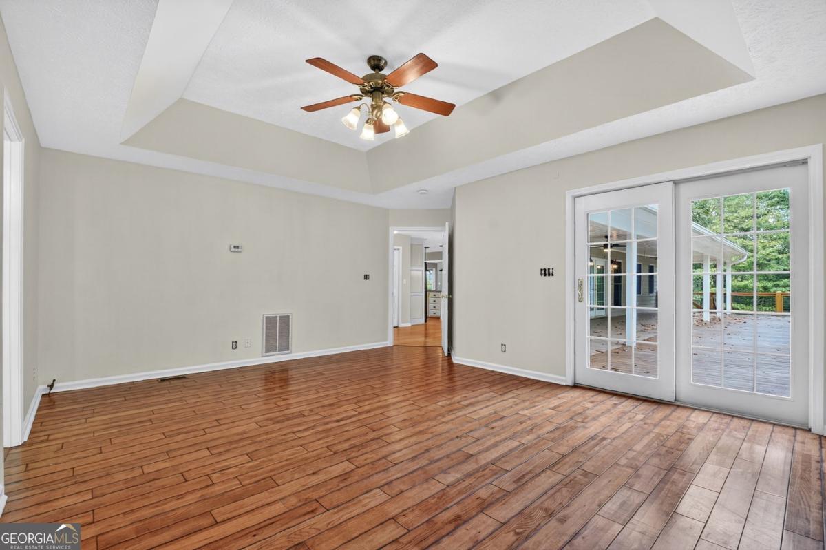 344 Cascade Lane Blue Ridge, GA 30513 - Photo 42 of 62 a view of an empty room with wooden floor and a window
