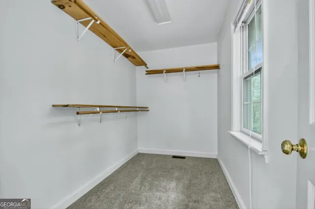 a view of an empty room with a fireplace