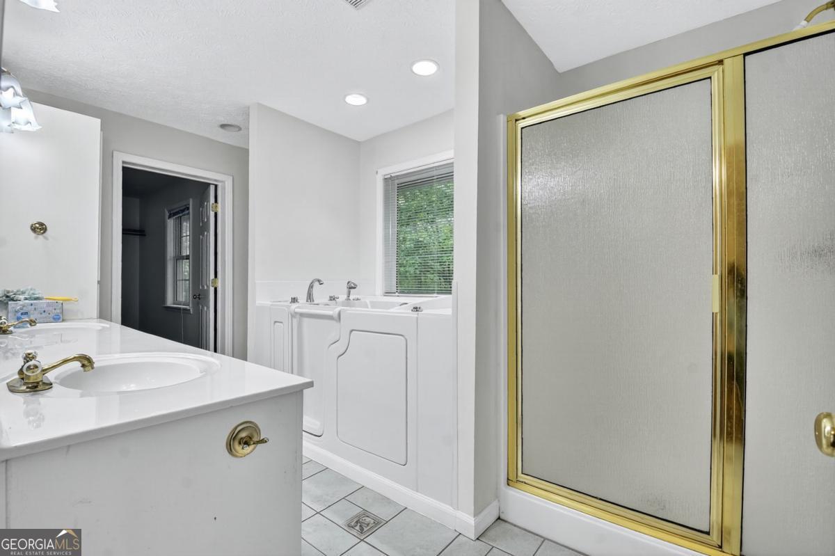 344 Cascade Lane Blue Ridge, GA 30513 - Photo 45 of 62 a bathroom with a sink a mirror and a shower