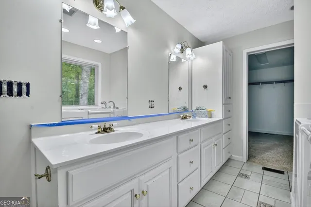 an empty room with a ceiling fan and a large window