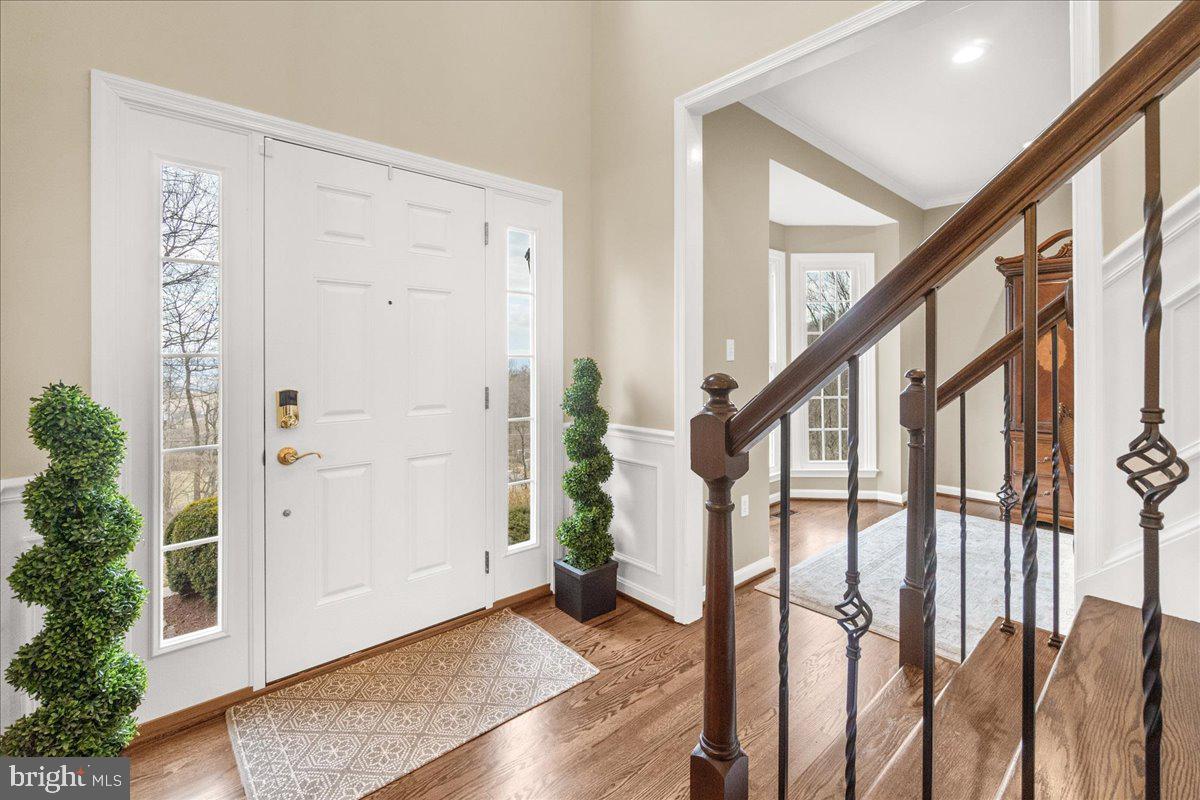 8029 Ridge Road Frederick, MD 21702 - Photo 16 of 91 a view of an entryway with wooden floor and stairs