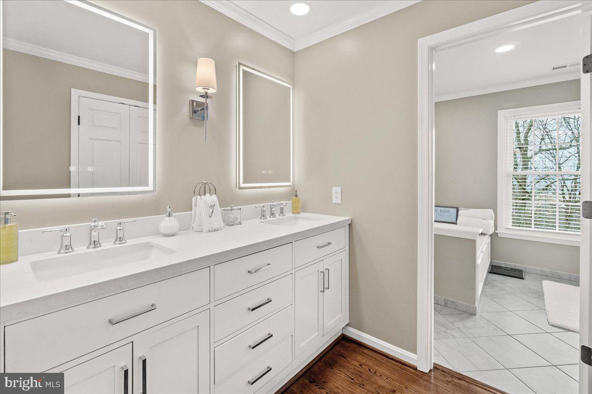 8029 Ridge Road Frederick, MD 21702 - Photo 45 of 91 a bathroom with a double vanity sink a mirror and a shower