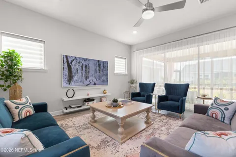 a living room with furniture and a large window